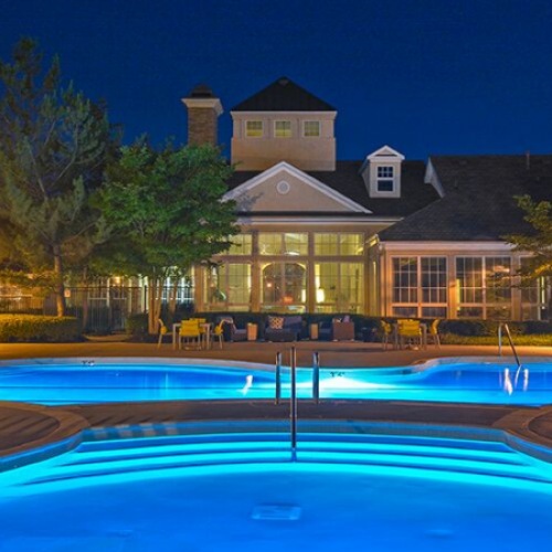 Resort-style swimming pool with lounge chairs